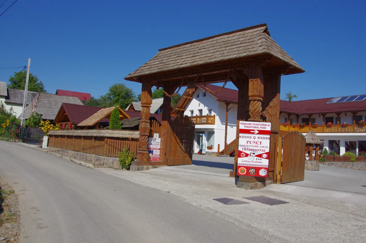 The entrance to the village of Breb, with the carved wooden gate of the guesthouse